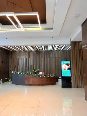 a lobby with a screen in the middle of a building at Sunset Studio in Manila