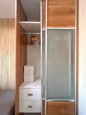 a walk in closet with a glass door at Sunset Studio in Manila