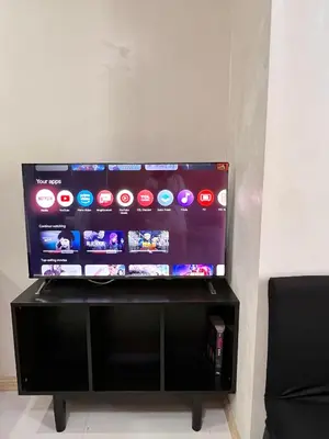 a flat screen tv sitting on top of a black stand at Sunset Studio in Manila