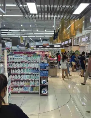 a store with people walking around a store at On Promo Condo 1BR Makati in Manila