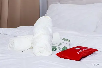a stuffed animal laying on a bed with a towel at On Promo Condo 1BR Makati in Manila