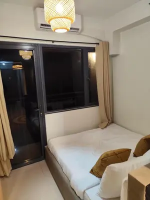 a small room with a bed and a window at Comfort Cove PH in Manila
