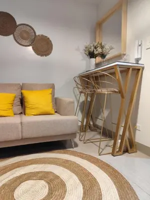 a living room with a couch and a table at Comfort Cove PH in Manila