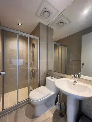 a bathroom with a toilet and a sink and a shower at GRAMERCY - SKY-VIEW 1 Bed escape with POOL & SPA Access in Manila