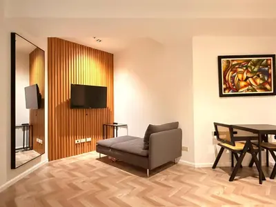 a living room with a chair and a table at GRAMERCY - SKY-VIEW 1 Bed escape with POOL & SPA Access in Manila