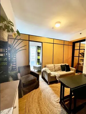 a living room with a couch and a table at Bali Inspired near BGC and NAIA in Manila