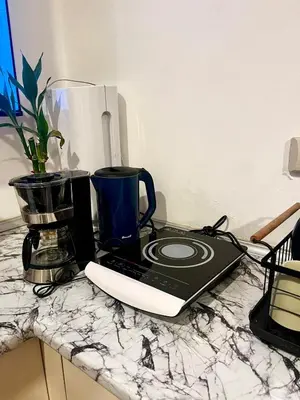 a laptop computer sitting on a counter with a blender at Bali Inspired near BGC and NAIA in Manila