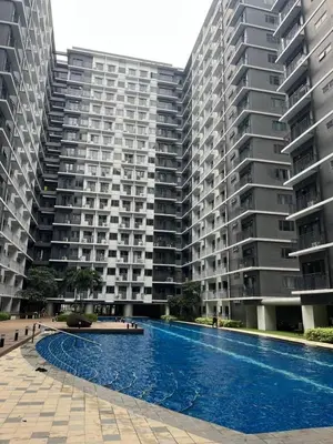 a large apartment building with a large swimming pool at Cozy Minimalist Unit at SMDC Shore 3 in Manila