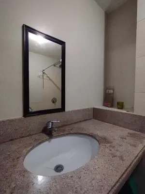 a bathroom with a sink and a mirror at Siena Park by Casa Stellar Bicutan Paranaque in Manila