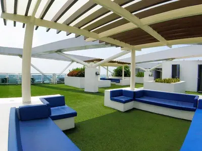 a group of blue benches under a pavilion at Azure Urban Resort Parañaque in Manila