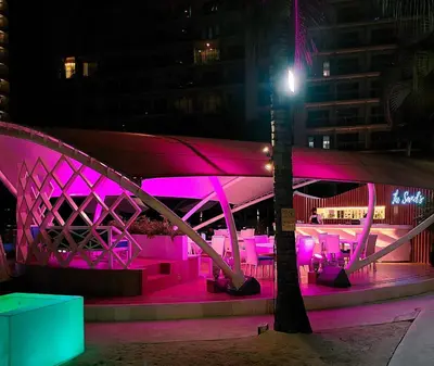 a bridge is lit up pink at night at Azure Urban Resort Parañaque in Manila