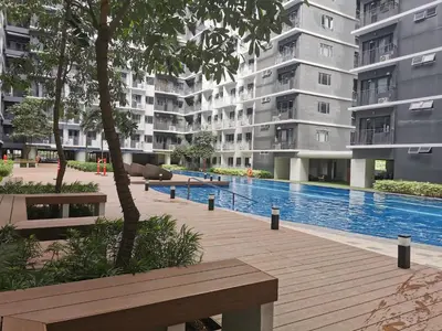 a swimming pool in the middle of a building at aldo shore 3 residence mall of asia in Manila