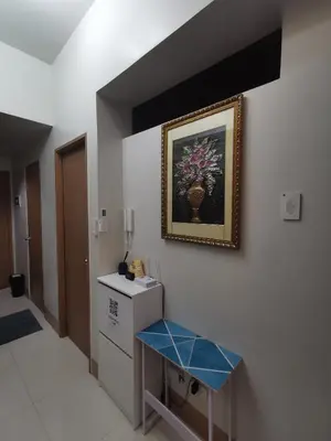 a bathroom with a picture of a vase on the wall at aldo shore 3 residence mall of asia in Manila