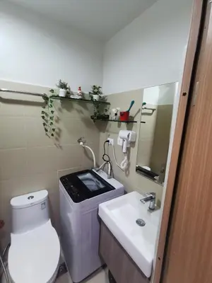 a bathroom with a toilet and a sink and a mirror at aldo shore 3 residence mall of asia in Manila