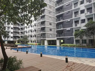 a large apartment building with a large swimming pool at aldo shore 3 residence mall of asia in Manila