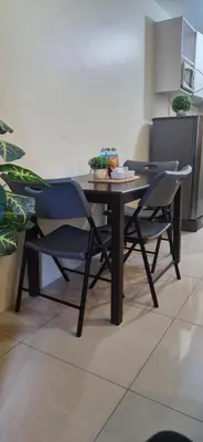 a dining table and two chairs in a kitchen at Urban Escape- SM Jazz Residences in Manila