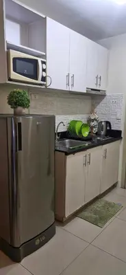 a kitchen with a sink and a microwave at Urban Escape- SM Jazz Residences in Manila