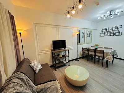 a living room with a couch and a table at Cozy 2-BR Perfect for Families and Friends in Manila