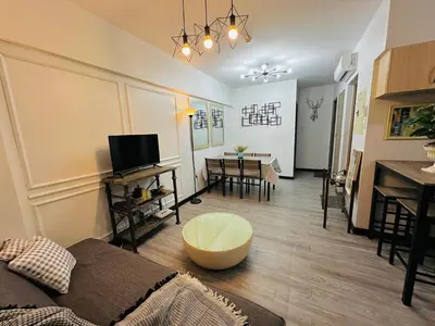 a living room with a couch and a table at Cozy 2-BR Perfect for Families and Friends in Manila