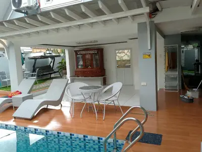 a house with a pool and a table and chairs at Montalban Villa in General Trias