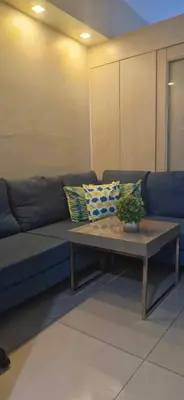 a blue couch with pillows on it in a living room at SM JAZZ RESIDENCES-Urban Escape in Manila