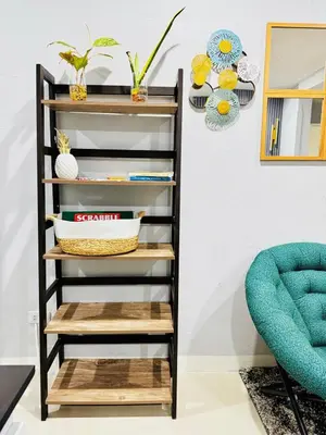a shelf in a living room with wooden shelves at Peaceful and cozy unit in Manila