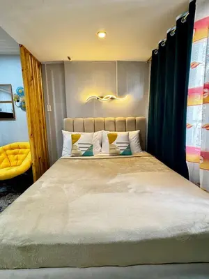 a bedroom with a large bed in a room at Peaceful and cozy unit in Manila