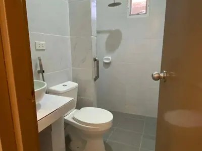 a bathroom with a toilet and a sink and a shower at Home of Joy Villa Peace House in Dasmariñas