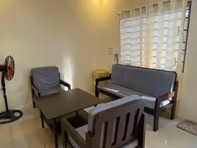 a living room with a couch and a table and chairs at Home of Joy Villa Peace House in Dasmariñas