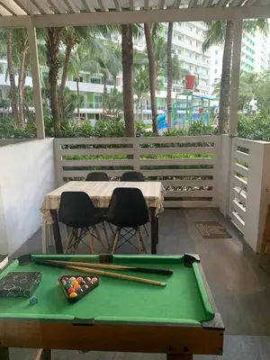 a pool table with bats and balls on a patio at Azure Urban Resort - Rio Tower in Manila