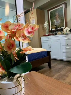 a vase with flowers on a table in a room at Azure Urban Resort - Rio Tower in Manila
