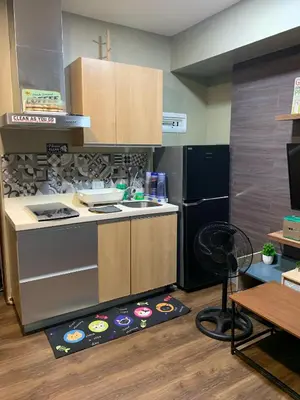 a kitchen with a stove and a kitchen rug at Azure Urban Resort - Rio Tower in Manila