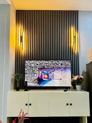 a flat screen tv sitting on top of a white cabinet at Peaceful and cozy unit in Manila