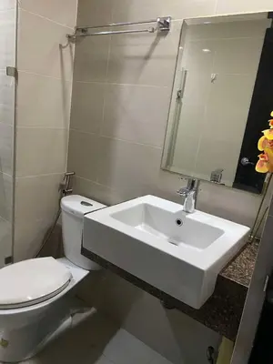 a white bathroom with a toilet and a sink at JOVYNOEL Condominium Unit Rental in Manila