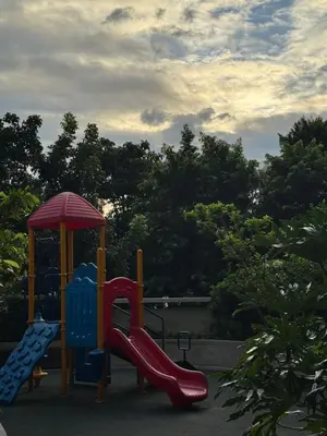 a playground with two slides and an umbrella at 1BR Condo Near Venice Canal & BGC with Great View - 20k in Manila
