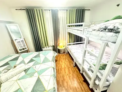 a bedroom with two bunk beds and a mirror at HiYara Loft - GA Tower 2, beside MRT BONI Station in Manila