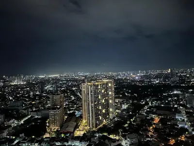 a view of a city at night at HiYara Loft - GA Tower 2, beside MRT BONI Station in Manila