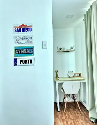 a room with a desk and a sign on the wall at HiYara Loft - GA Tower 2, beside MRT BONI Station in Manila