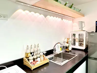 a kitchen with a sink and a counter top at HiYara Loft - GA Tower 2, beside MRT BONI Station in Manila