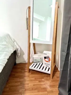 a mirror in a room next to a bed at HiYara Loft - GA Tower 2, beside MRT BONI Station in Manila
