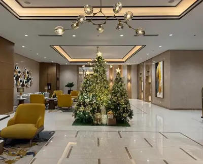a christmas tree in the lobby of a hotel at New 1BR Condo Near Venice Canal & BGC with Balcony - 7e in Manila