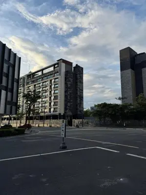 an empty street in front of a large building at New 1BR Condo Near Venice Canal & BGC with Balcony - 7e in Manila