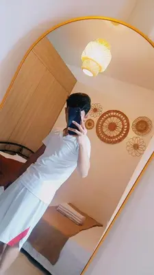 a man taking a picture of himself in a mirror at Shore Residences Moa Area Pasay City in Manila