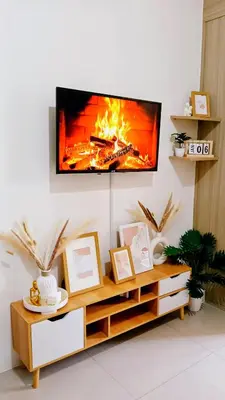 a living room with a tv on a wall at Shore Residences Moa Area Pasay City in Manila