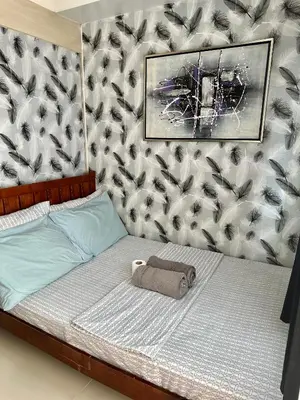a bedroom with a bed with a towel on it at Staycation Near Moa by Jen in Manila