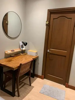 a room with a desk with a mirror and a door at Cozy, Spacious 1 Bedroom Condo, reach St Lukes BGC by foot in Manila