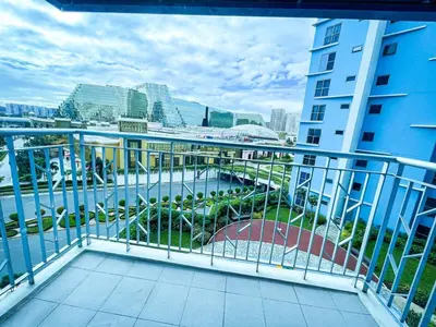 a balcony with a view of a river and buildings at Luxury 2BR Corner near Solaire & Okada II Sunset in Manila