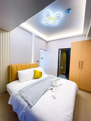 a bedroom with a bed with a ceiling with a butterfly on it at Ultra Luxury 1BR near Solaire & Okada in Manila