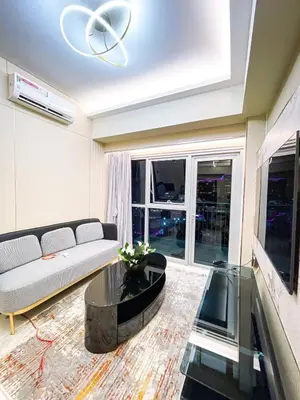 a living room with a couch and a table at Ultra Luxury 1BR near Solaire & Okada in Manila