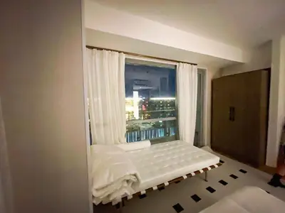 a small room with a window with white curtains at Luxury 2BR Penthouse across City of Dreams in Manila